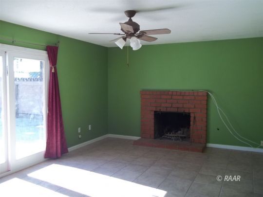 305 West Perdew Avenue Ridgecrest, CA 93555 - Photo 4 of 9 a living room with furniture and a fireplace
