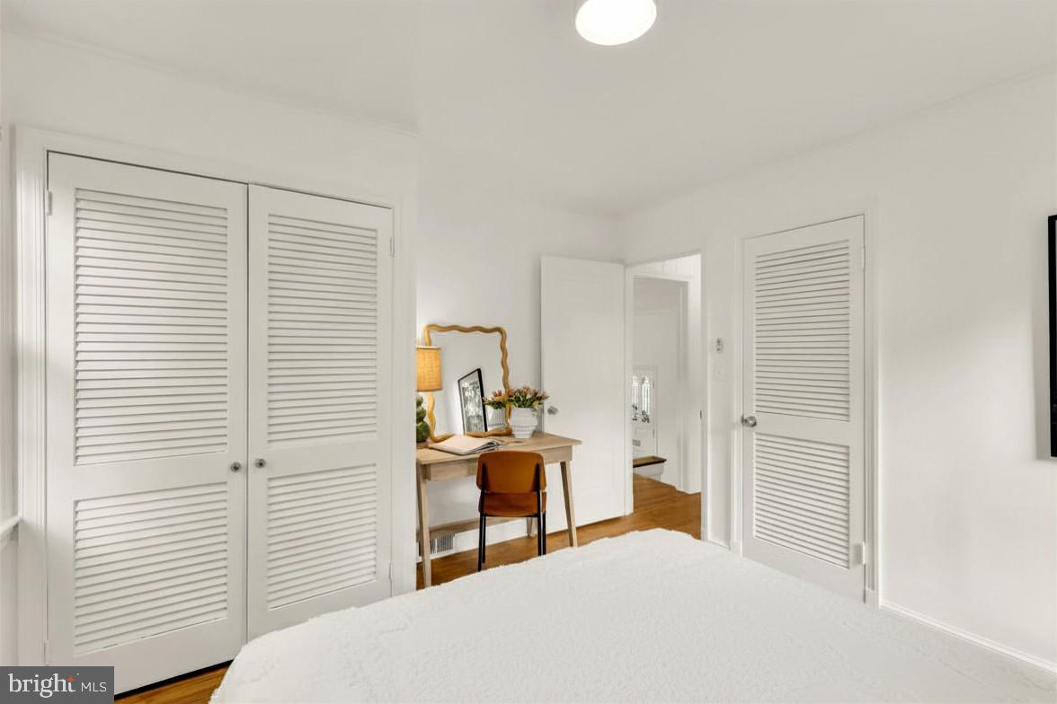 2030 Luzerne Avenue Silver Spring, MD 20910 - Photo 21 of 25 a bedroom with a bed and a chandelier