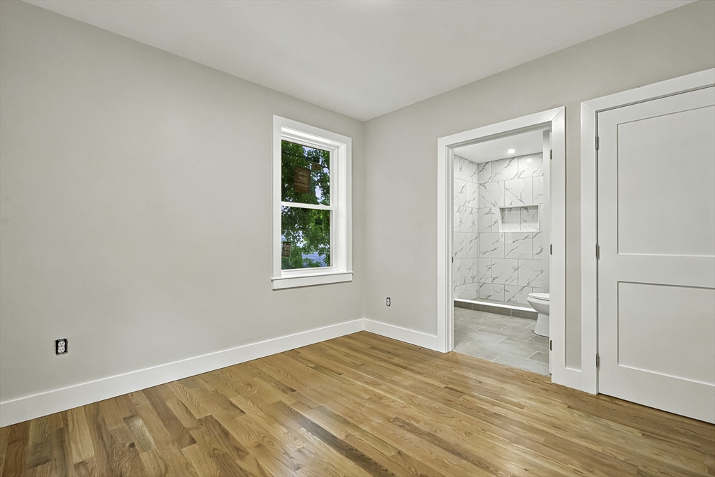 4 Mayhew Street Framingham, MA 01702 - Photo 24 of 42 an empty room with wooden floor and a window