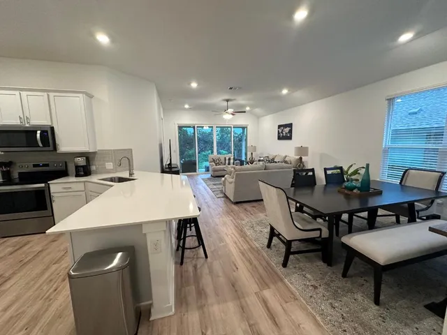 a large kitchen with a table and chairs
