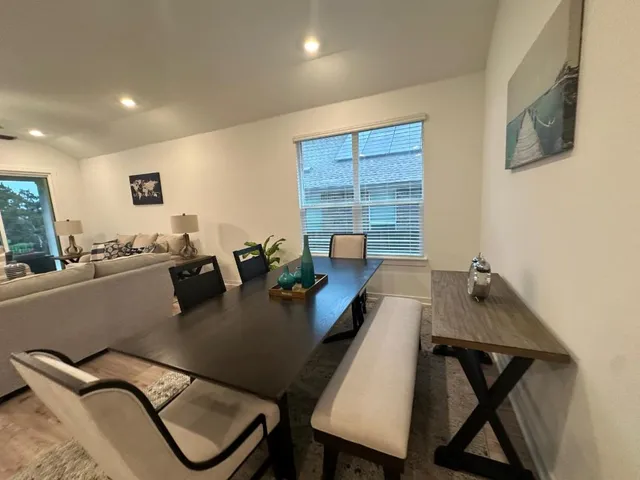 a view of a workspace room with furniture and window