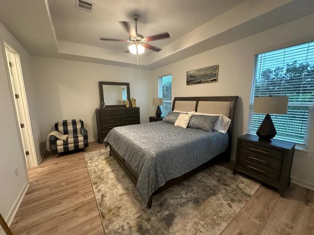a bedroom with a bed and a chandelier