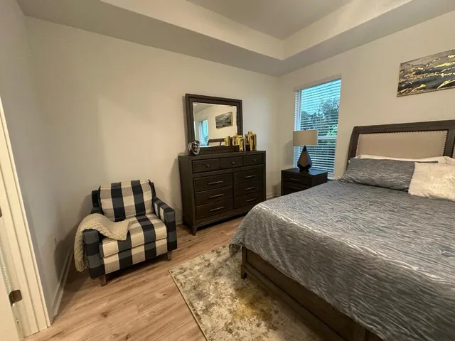 a bedroom with a bed and dresser