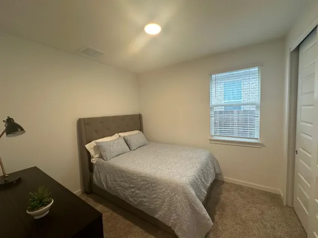 a bedroom with a bed and window