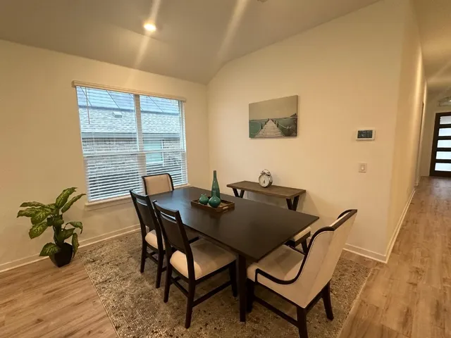 a view of a dining room with furniture and wooden floor