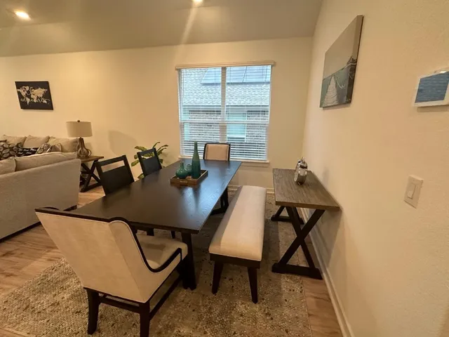 a view of a workspace room with furniture and window