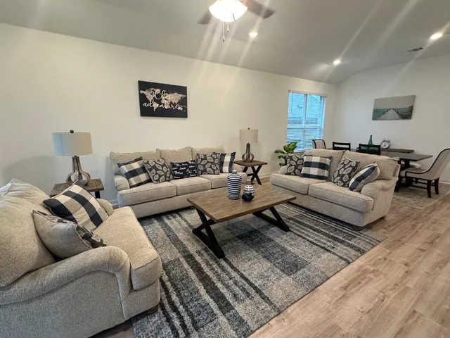 a living room with furniture and a rug