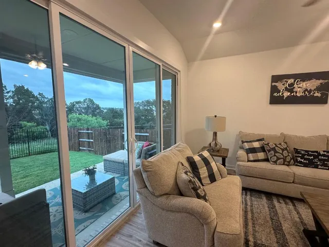 a living room with couch and a floor to ceiling window