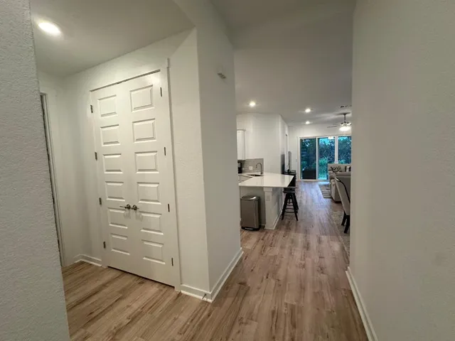 a kitchen with a refrigerator and a stove top oven