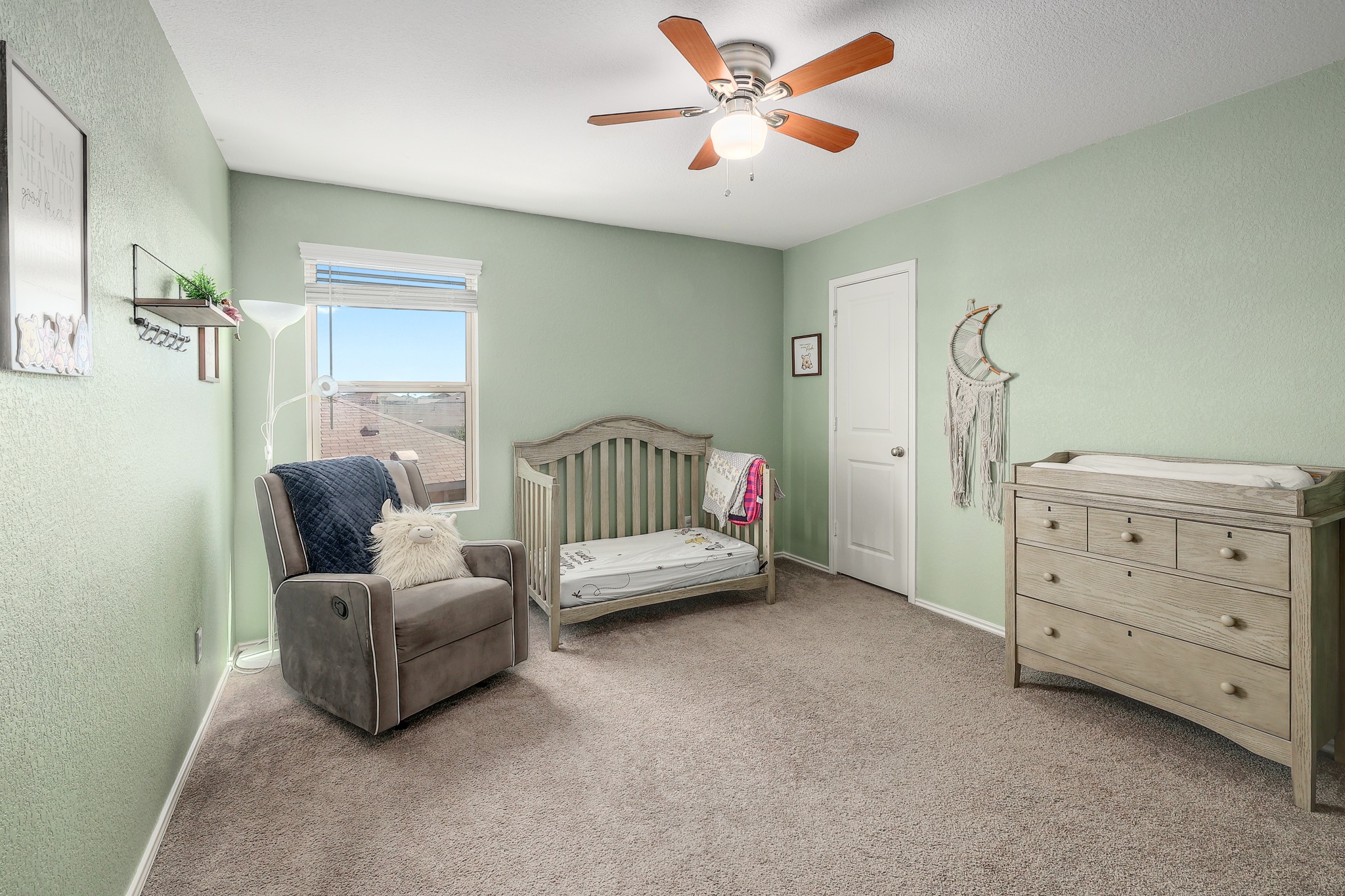 735 Circle Way Jarrell, TX 76537 - Photo 18 of 32 Soft wall colors and wall-to-wall carpeting create a comfortable atmosphere in this upstairs bedroom.