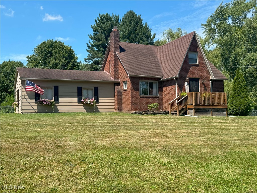 95 Clingan Road Struthers, OH 44471 - Photo 2 of 46 Front view of house with a lawn, a chimney, brick siding, and a shingled roof