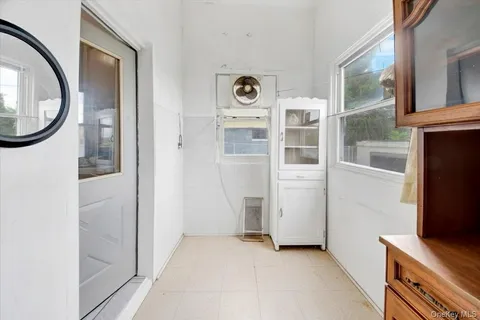 a view of a livingroom with an entryway and wooden floor