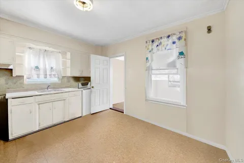 a kitchen with granite countertop cabinets and window