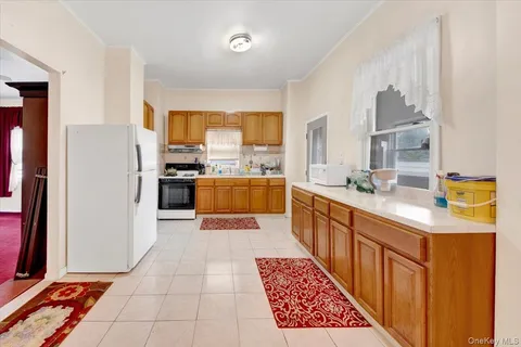 a kitchen with stainless steel appliances granite countertop a refrigerator a sink dishwasher stove and oven