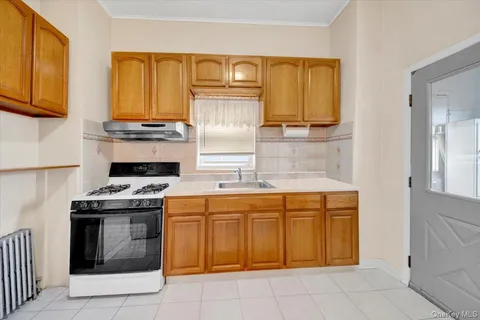 a kitchen with a stove top oven sink and cabinets