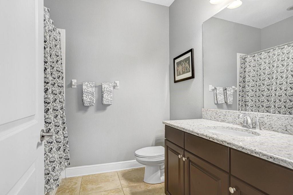 11719 Albatross Lane Riverview, FL 33569 - Photo 30 of 51 a bathroom with a granite countertop toilet a sink and a mirror