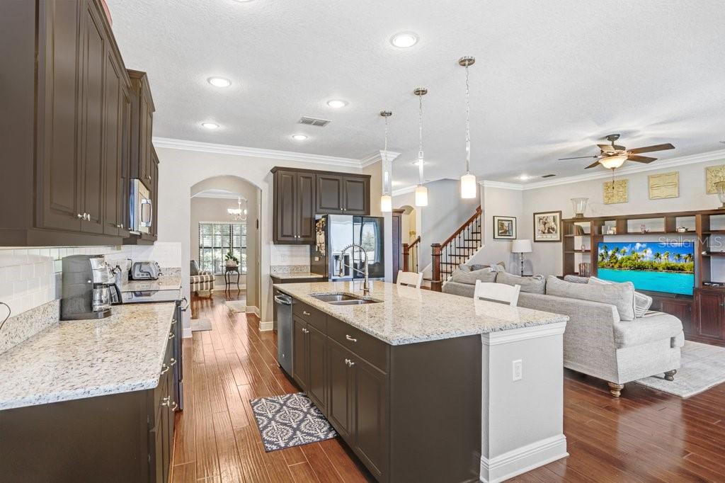 11719 Albatross Lane Riverview, FL 33569 - Photo 4 of 51 a large white kitchen with a large island in the center