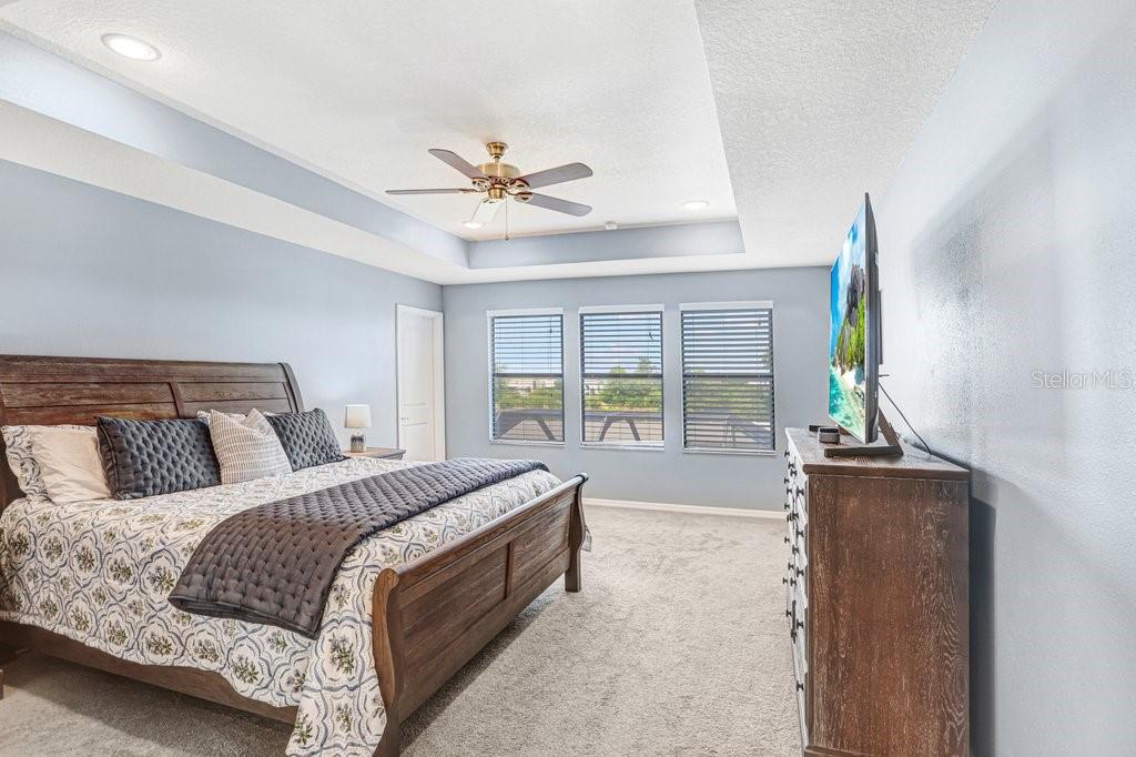 11719 Albatross Lane Riverview, FL 33569 - Photo 5 of 51 a bedroom with a large bed and a window