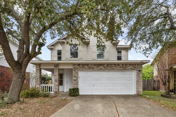 front view of a house with a tree