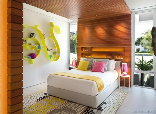 a bedroom with a bed and painting on the wall