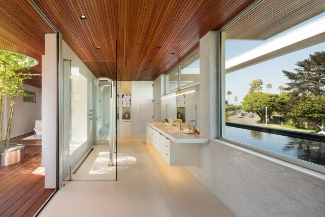 a large white room with a large window and furniture