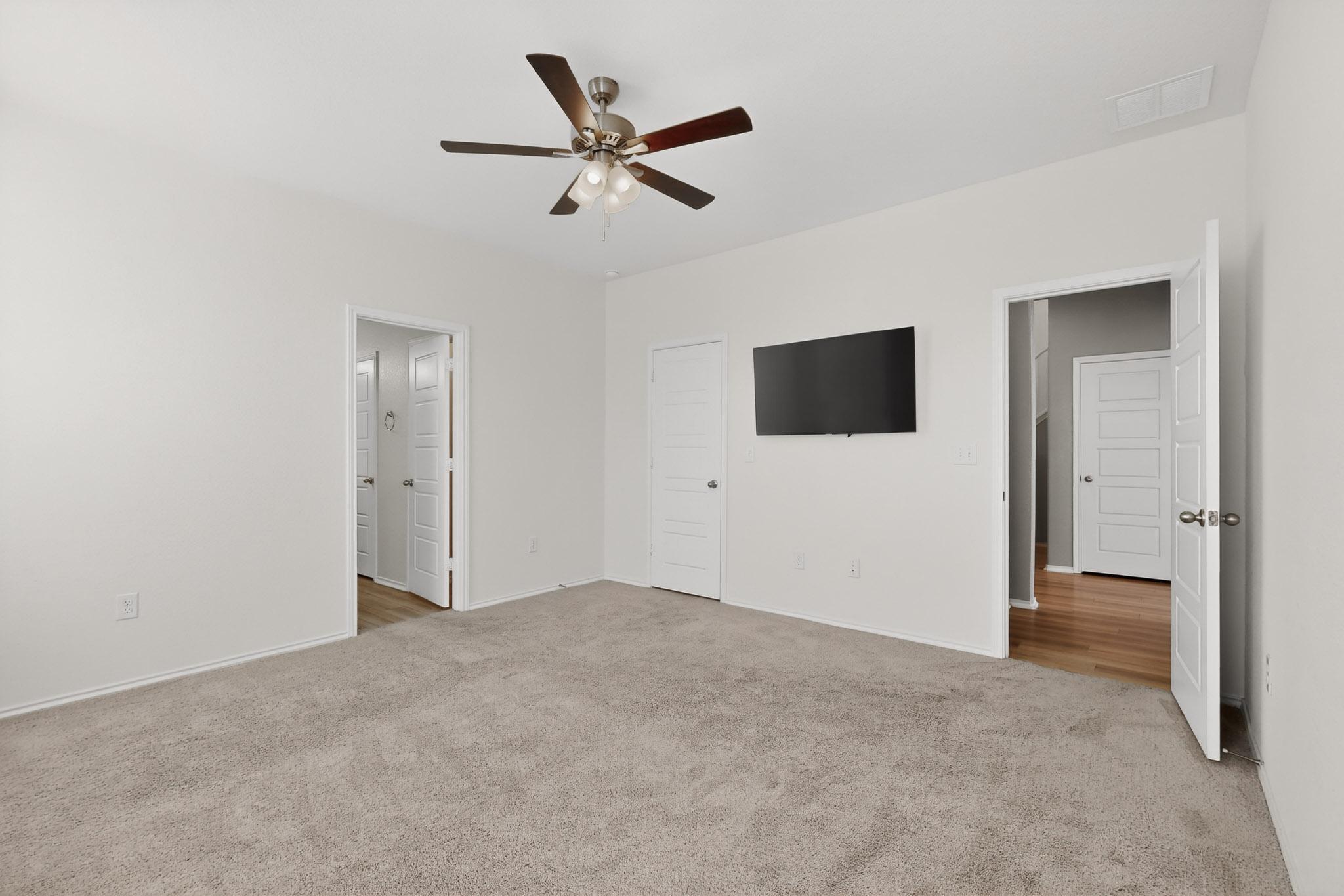 14513 Booted Eagle Pass Elgin, TX 78621 - Photo 19 of 33 Another view of the primary bedroom highlighting the generous layout and direct access to the en suite bath.