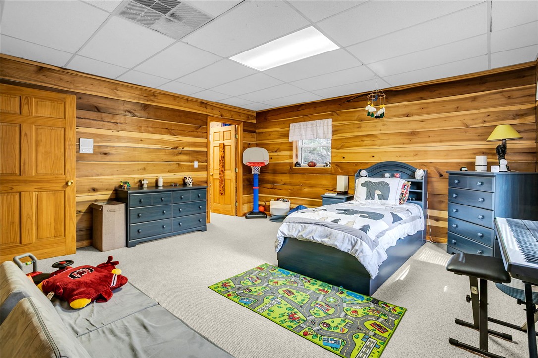 130 Greenbrier Road Salem, SC 29676 - Photo 13 of 42 This inviting bedroom features natural wood paneled walls, a neutral carpet, and ample natural light.