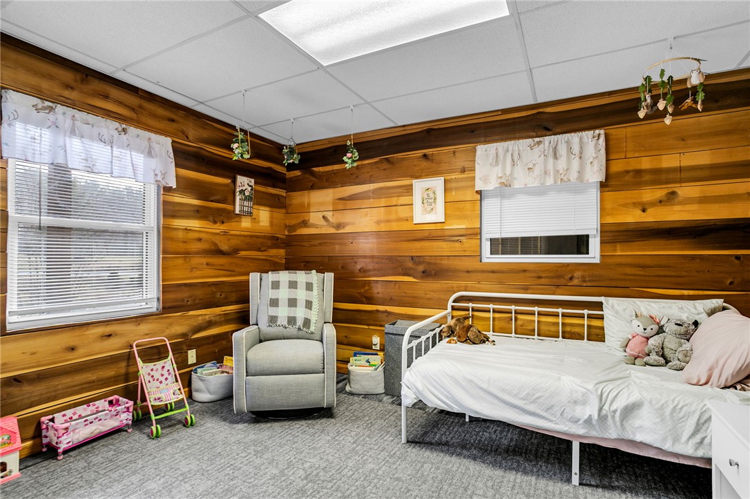 130 Greenbrier Road Salem, SC 29676 - Photo 15 of 42 This cozy bedroom features warm wood paneling, offering a rustic yet inviting atmosphere.