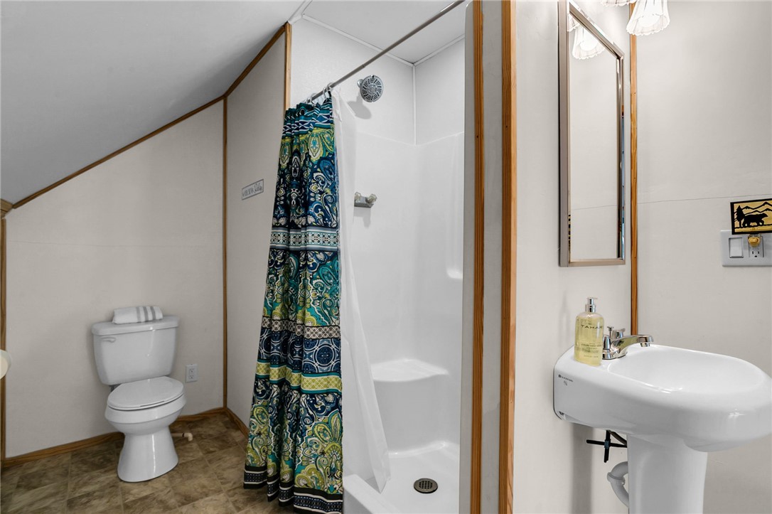 130 Greenbrier Road Salem, SC 29676 - Photo 18 of 42 This bathroom features a shower, toilet, and a pedestal sink, with ample natural light.