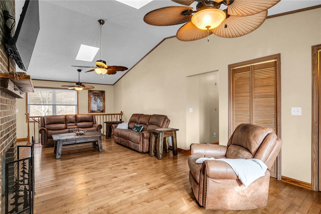 130 Greenbrier Road Salem, SC 29676 - Photo 23 of 42 Warm and inviting living room featuring vaulted ceilings, skylights, and beautiful hardwood flooring.