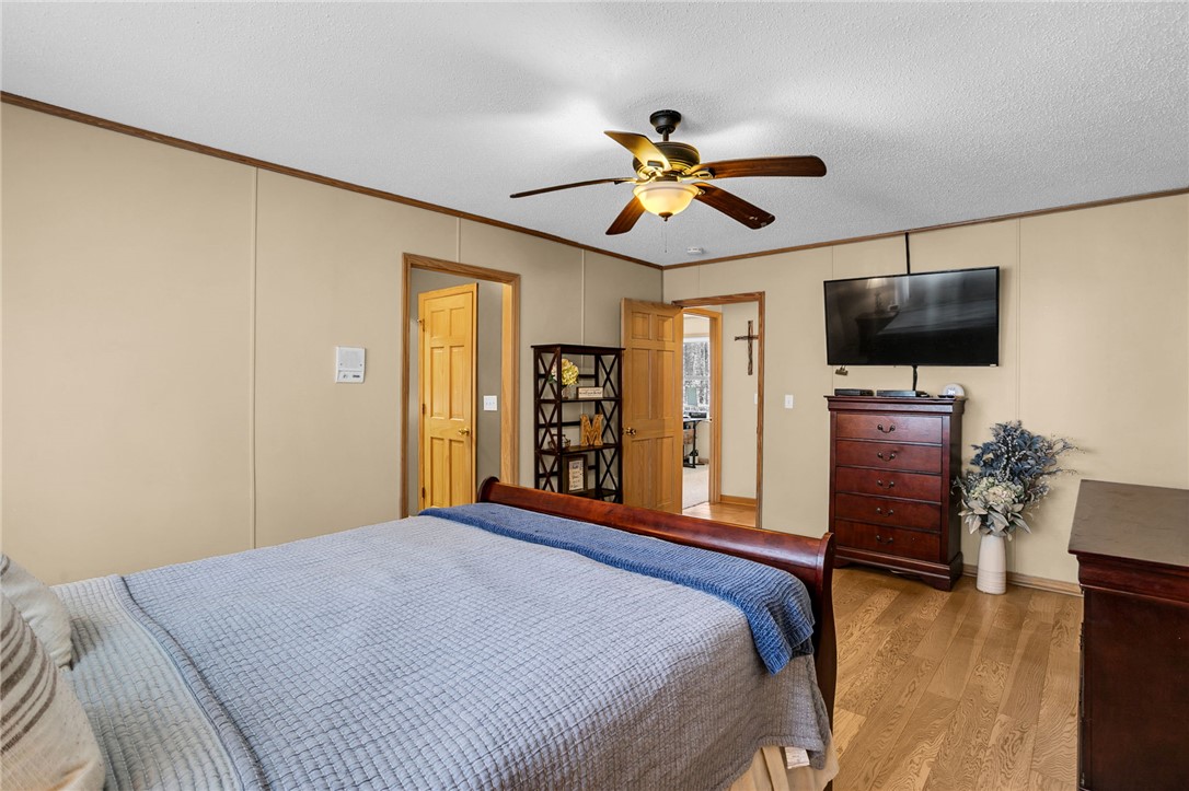 130 Greenbrier Road Salem, SC 29676 - Photo 27 of 42 This spacious bedroom features warm wood flooring and a refreshing ceiling fan.