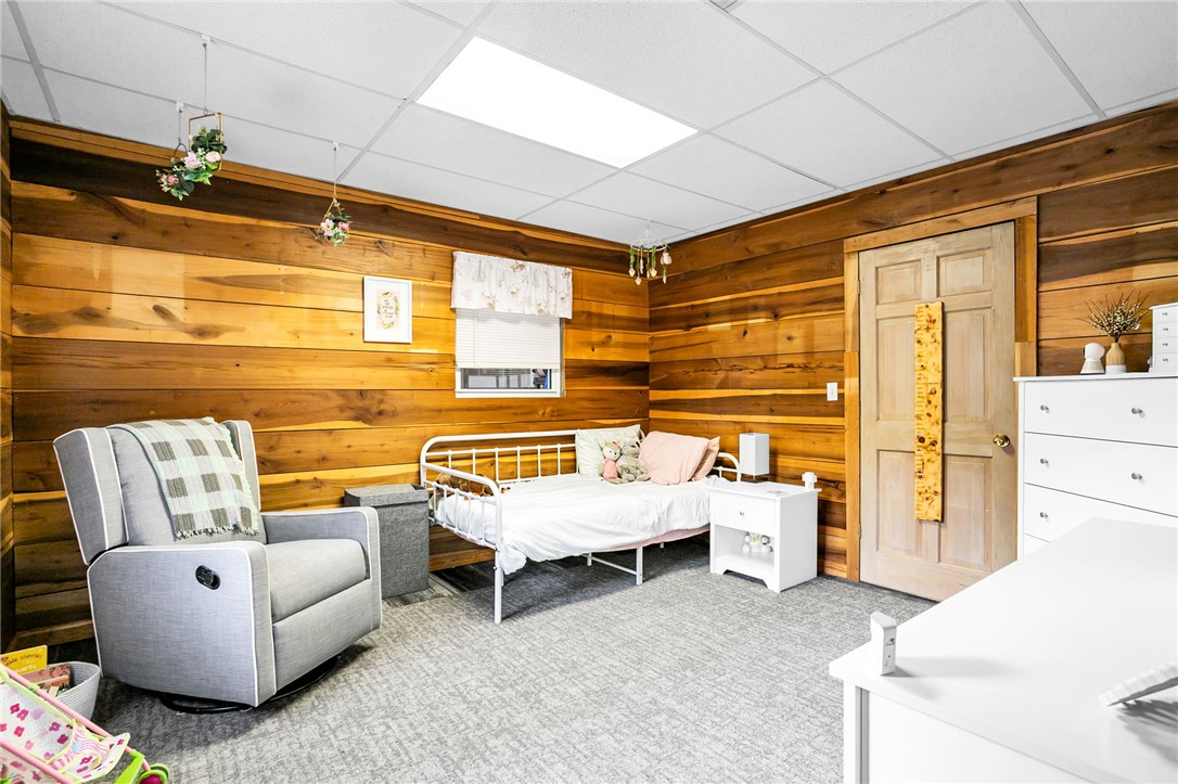 130 Greenbrier Road Salem, SC 29676 - Photo 32 of 42 This cozy bedroom features warm wood paneling and ample natural light, perfect for restful nights.