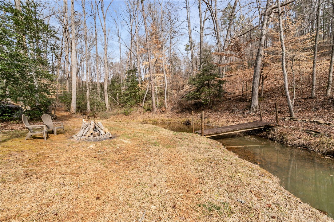 130 Greenbrier Road Salem, SC 29676 - Photo 39 of 42 This tranquil yard features a charming wooden bridge over a flowing stream, perfect for outdoor enjoyment.