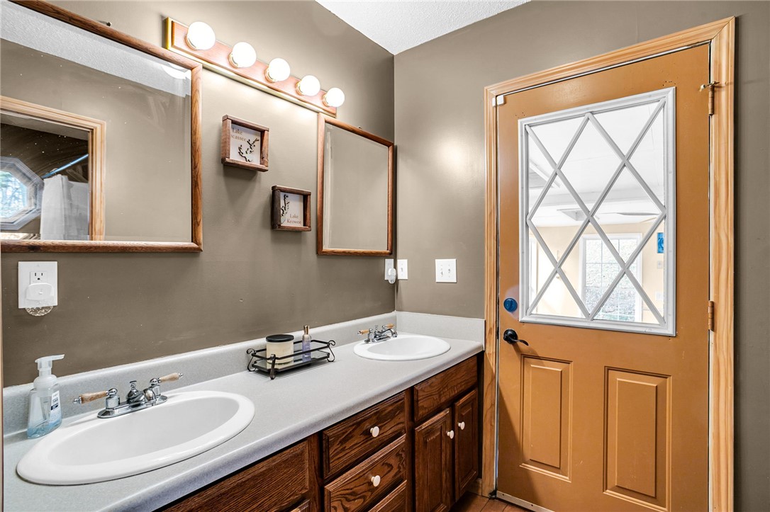 130 Greenbrier Road Salem, SC 29676 - Photo 8 of 42 This bathroom features dual sinks and a door with diamond-paned glass.