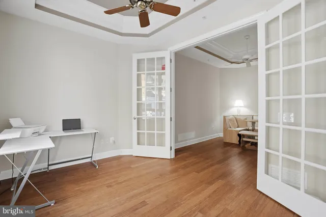 a workspace with wooden floor and a window