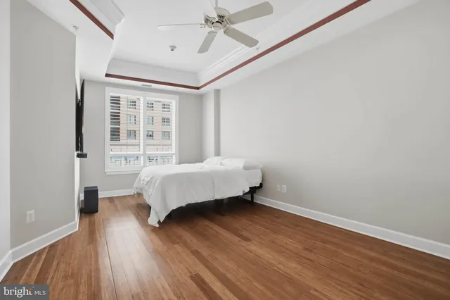 a bedroom with a bed and wooden floor
