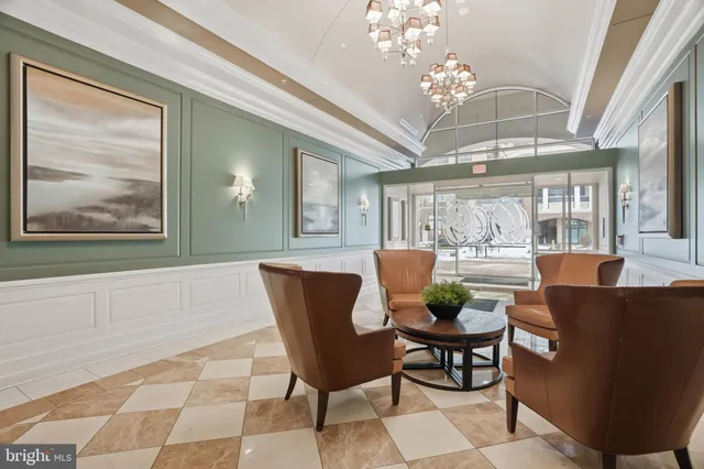 a view of a dining room with furniture and a chandelier