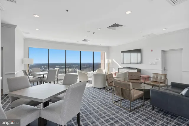 a living room with lots of furniture and a large window
