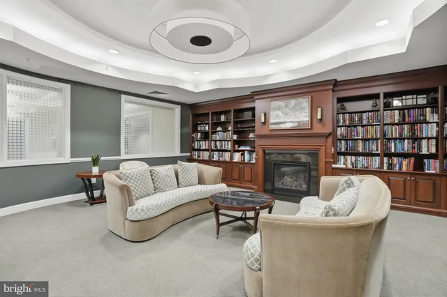 a dining hall with stainless steel appliances a dining table chairs and flat screen tv