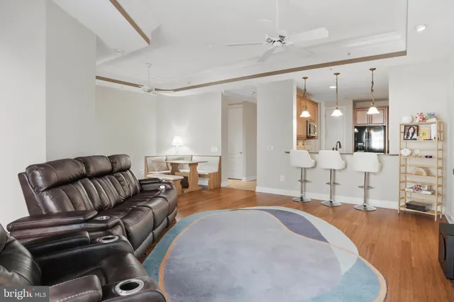 a spacious bedroom with a bed a couch and chandelier