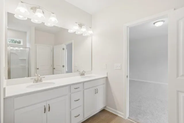 a bathroom with a double vanity sink and a mirror