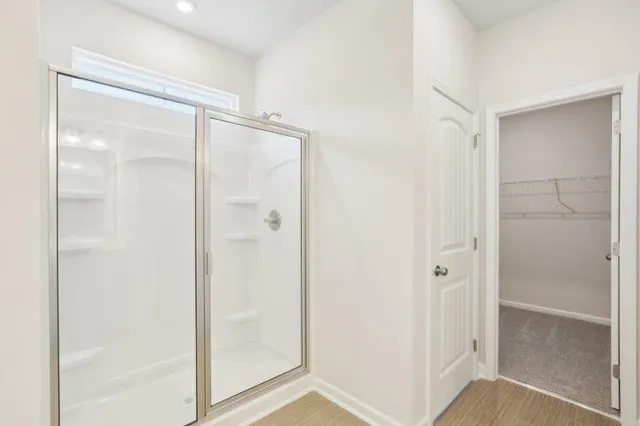 a bathroom with a glass shower door