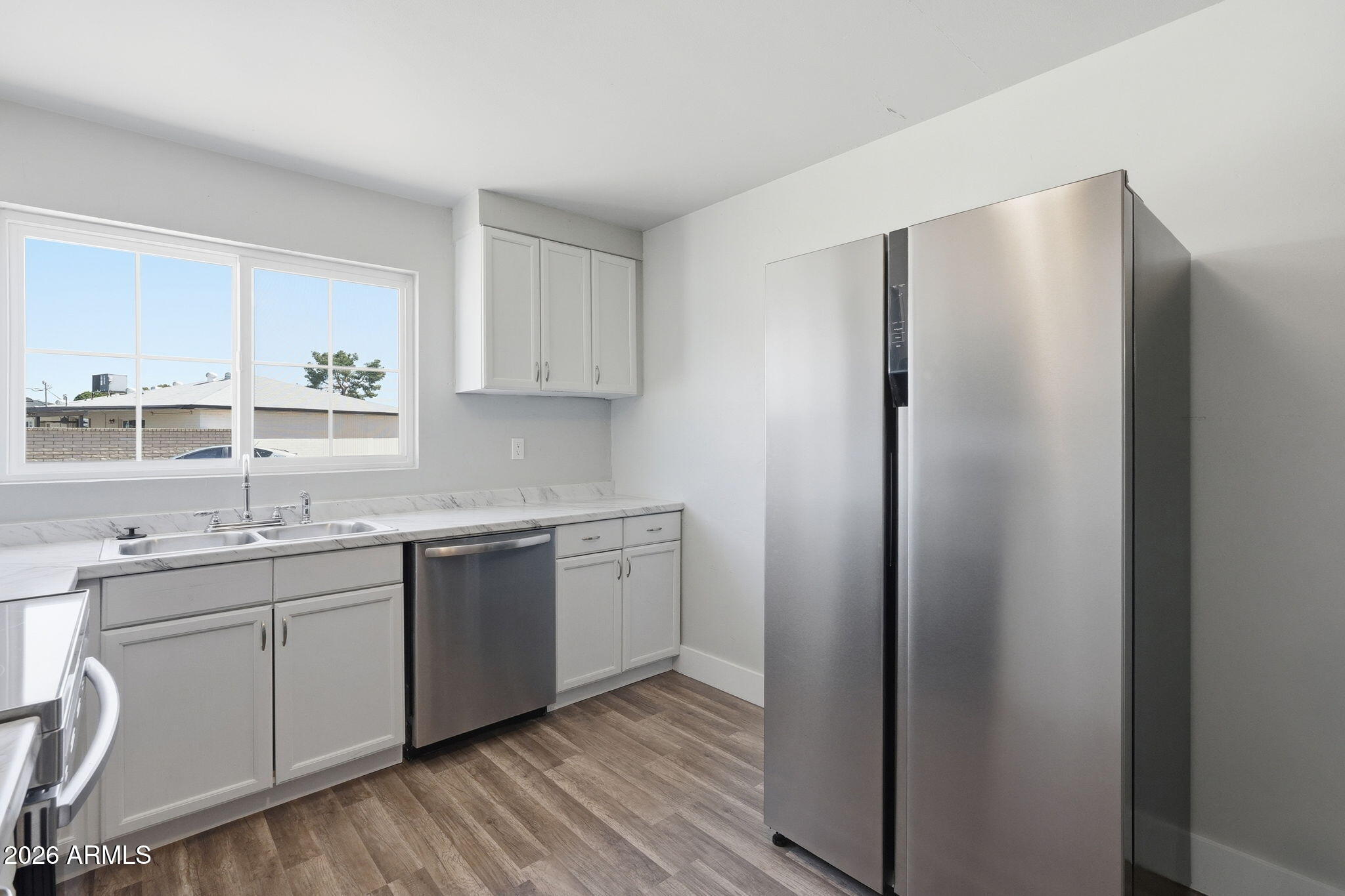 2206 West Rancho Drive Phoenix, AZ 85015 - Photo 12 of 29 a kitchen with stainless steel appliances granite countertop a refrigerator and a sink