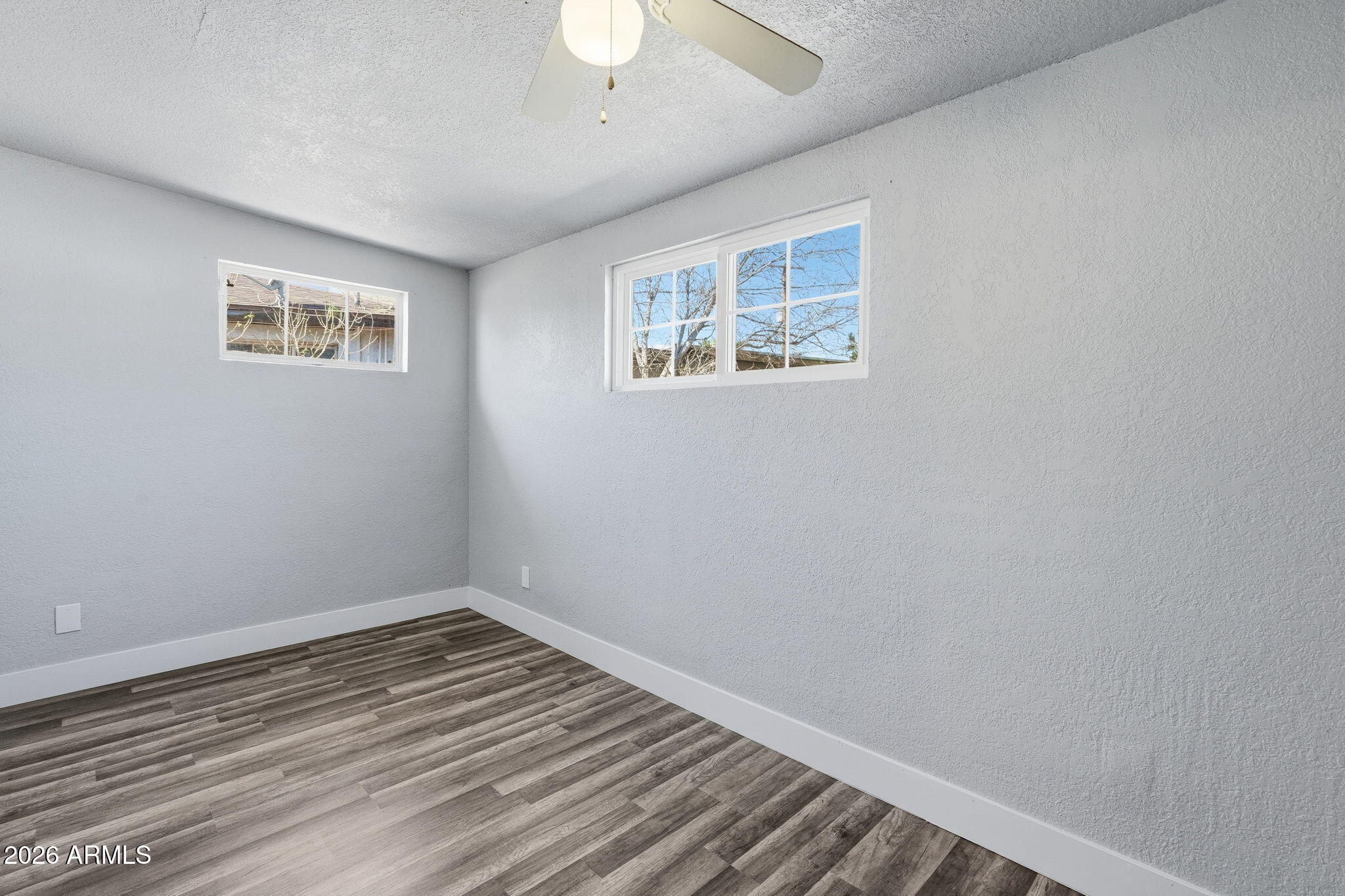 2206 West Rancho Drive Phoenix, AZ 85015 - Photo 19 of 29 a view of empty room with wooden floor
