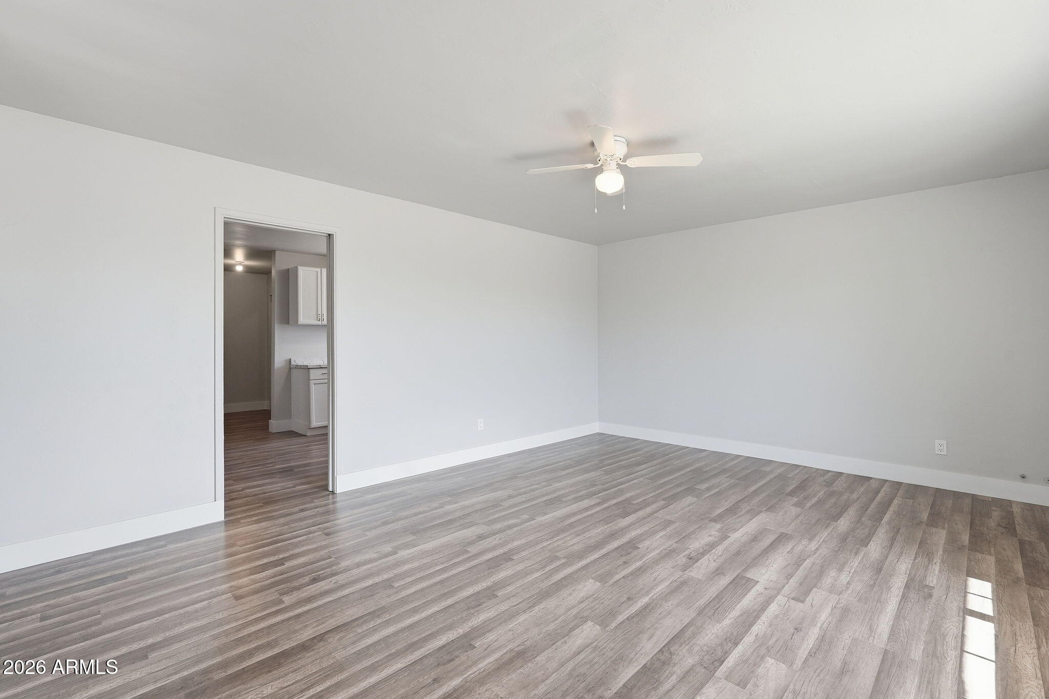 2206 West Rancho Drive Phoenix, AZ 85015 - Photo 21 of 29 a view of an empty room with wooden floor