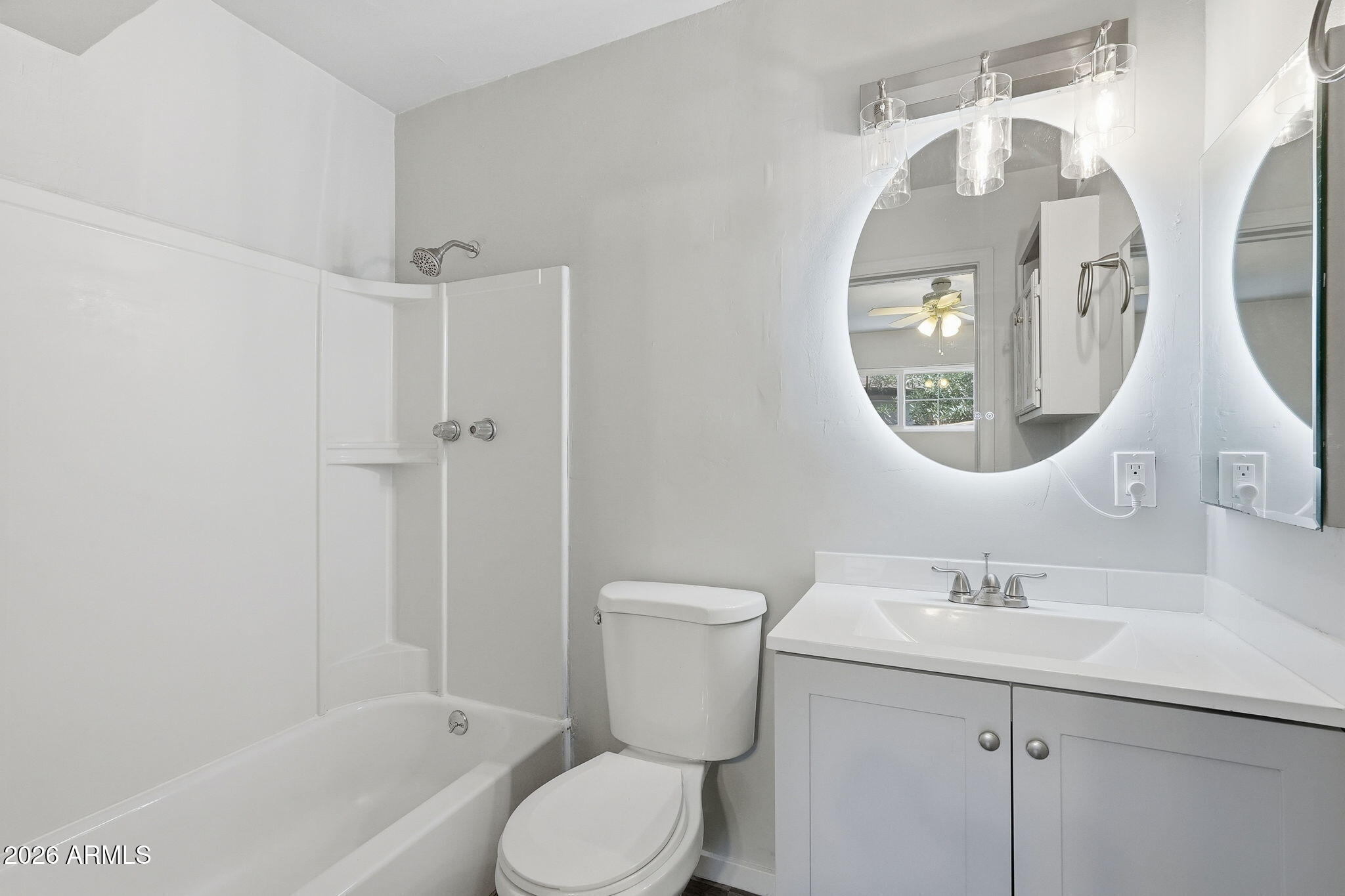 2206 West Rancho Drive Phoenix, AZ 85015 - Photo 3 of 29 a bathroom with a toilet sink and mirror