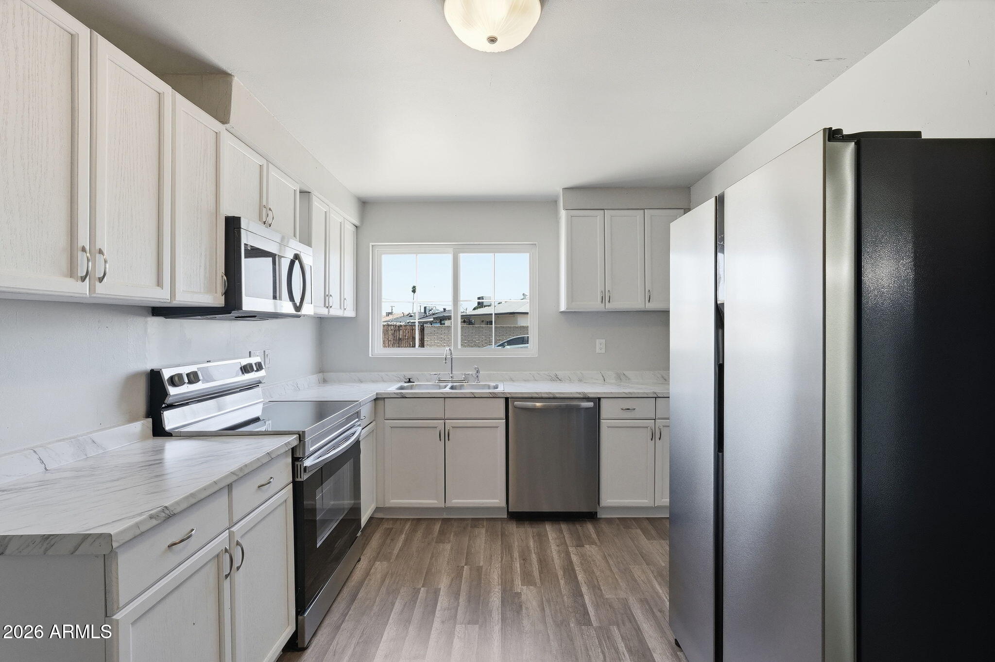 2206 West Rancho Drive Phoenix, AZ 85015 - Photo 8 of 29 a kitchen with stainless steel appliances granite countertop a sink stove and refrigerator