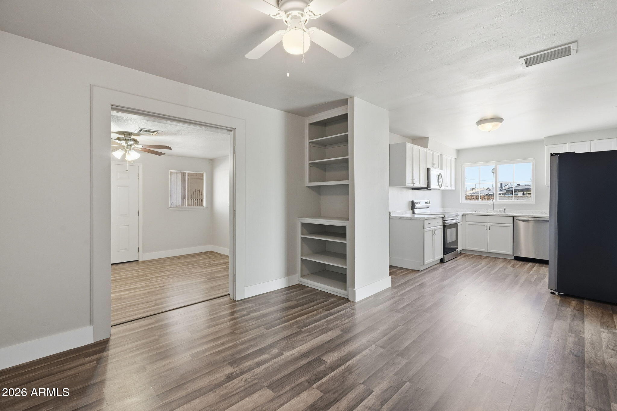 2206 West Rancho Drive Phoenix, AZ 85015 - Photo 10 of 29 a kitchen with stainless steel appliances a refrigerator and a wooden floor