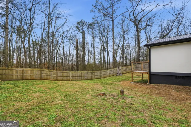 a kitchen with stainless steel appliances granite countertop white cabinets granite counter tops and a wooden floors
