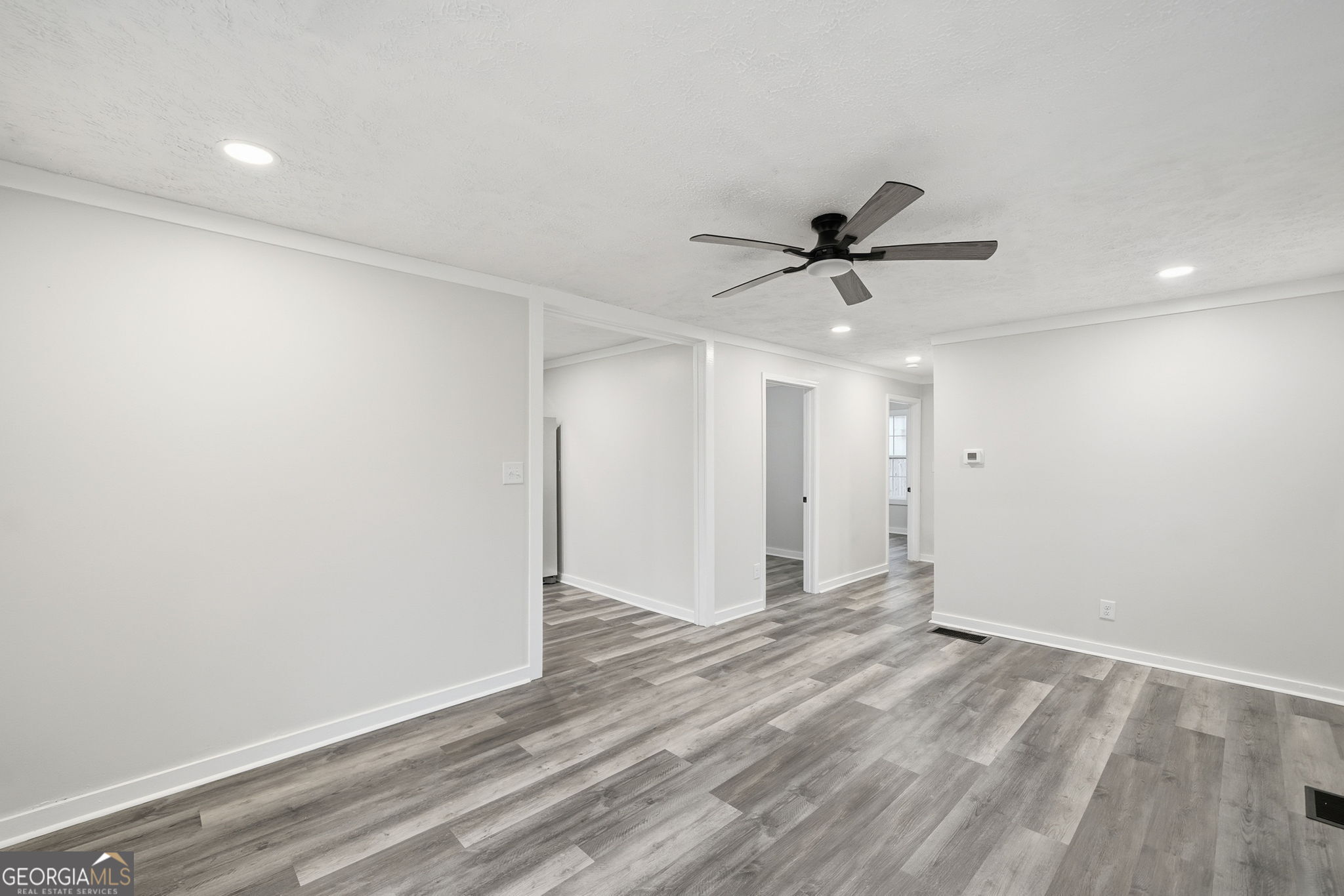 1734 Ball Ground Road Ball Ground, GA 30107 - Photo 16 of 31 an empty room with a ceiling fan and carpet